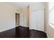 Bedroom with dark wood floors, a window with blinds, and a closet at 20316 Natures Corner Dr, Tampa, FL 33647