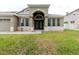Inviting front entrance with decorative double doors, stone accents, and a well-kept lawn at 20316 Natures Corner Dr, Tampa, FL 33647