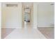 Open hallway with tile flooring connecting to carpeted rooms; great for showcasing decor and providing seamless transition at 20316 Natures Corner Dr, Tampa, FL 33647