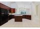Spacious kitchen with stainless steel appliances, granite countertops, and dark wood cabinetry at 20316 Natures Corner Dr, Tampa, FL 33647
