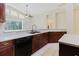 Modern kitchen with granite countertops, stainless steel sink, and a large window for natural light at 20316 Natures Corner Dr, Tampa, FL 33647