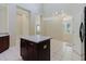 Kitchen with island, tile floor and neutral paint with modern lighting at 20316 Natures Corner Dr, Tampa, FL 33647