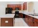 Well-equipped kitchen featuring black appliances, ample counter space, and sleek dark brown cabinets at 20316 Natures Corner Dr, Tampa, FL 33647