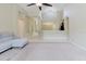 Spacious living room with vaulted ceilings, fan, and view into the kitchen at 20316 Natures Corner Dr, Tampa, FL 33647