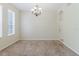 Inviting living area featuring soft carpet flooring, neutral walls, and a decorative chandelier at 20316 Natures Corner Dr, Tampa, FL 33647