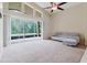 Bright living room features large glass sliding doors, vaulted ceilings, and a ceiling fan at 20316 Natures Corner Dr, Tampa, FL 33647