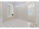 Inviting living room showcasing an open floorplan with tile flooring and neutral paint colors throughout at 20316 Natures Corner Dr, Tampa, FL 33647