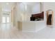 Open concept showcasing kitchen with dark cabinets with an island, tiled floors, and neutral walls at 20316 Natures Corner Dr, Tampa, FL 33647