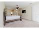 Carpeted main bedroom with fan, window and view to the bathroom entrance at 20316 Natures Corner Dr, Tampa, FL 33647