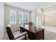 Bright home office featuring three windows, neutral walls, carpet flooring, and an elegant entryway at 20316 Natures Corner Dr, Tampa, FL 33647