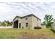 The rear exterior of the home features a screened lanai and well-maintained yard at 20316 Natures Corner Dr, Tampa, FL 33647