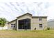 The rear exterior of the home features a screened lanai and well-maintained yard at 20316 Natures Corner Dr, Tampa, FL 33647