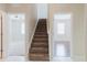 Stairway with carpeted steps, white trim, and views into adjacent rooms at 20316 Natures Corner Dr, Tampa, FL 33647