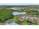 Aerial view of the community showcasing the surrounding landscape, lakes, and numerous rooftops at 20831 Valprato Ct, Venice, FL 34293