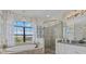 Relaxing bathroom with a soaking tub, walk-in shower and large window at 20831 Valprato Ct, Venice, FL 34293