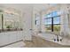 Elegant bathroom featuring a soaking tub, tiled shower, and floral wallpaper at 20831 Valprato Ct, Venice, FL 34293