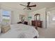 The main bedroom has a television, a large bed, and a scenic view at 20831 Valprato Ct, Venice, FL 34293