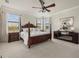Elegant primary bedroom suite with four poster bed, fireplace, and scenic views at 20831 Valprato Ct, Venice, FL 34293
