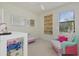 Playful bedroom with colorful decor, a large mirror, and a bright window at 20831 Valprato Ct, Venice, FL 34293
