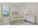 Bright and cheerful bedroom with daybed, large mirror, and whimsical decor at 20831 Valprato Ct, Venice, FL 34293