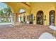 Grand clubhouse entrance featuring arched doorways, stone accents, and landscaped surroundings at 20831 Valprato Ct, Venice, FL 34293