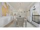 Bright dining room boasts a crystal chandelier, neutral décor, and natural light at 20831 Valprato Ct, Venice, FL 34293