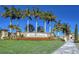 Elegant community sign surrounded by lush landscaping and towering palm trees at 20831 Valprato Ct, Venice, FL 34293