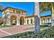 Beautiful community building featuring grand arches, lush landscaping, and a welcoming entrance at 20831 Valprato Ct, Venice, FL 34293