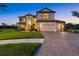 Stunning two-story home with a tile roof, large windows, and a three-car garage at 20831 Valprato Ct, Venice, FL 34293