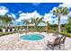 Community hot tub surrounded by chairs and lovely landscaping for a resort-style experience at 20831 Valprato Ct, Venice, FL 34293