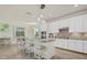 Spacious kitchen boasts white cabinetry, granite countertops, and an eat-in island at 20831 Valprato Ct, Venice, FL 34293