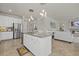 Spacious kitchen with a center island, granite countertops, stainless steel appliances, and seamless access to the living area at 20831 Valprato Ct, Venice, FL 34293