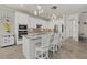 Bright kitchen with white cabinetry, stainless appliances, granite countertops, and an island at 20831 Valprato Ct, Venice, FL 34293
