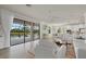 Bright open-concept living area with views of the pool and access to the kitchen at 20831 Valprato Ct, Venice, FL 34293