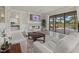 Comfortable living room featuring a fireplace, view of the pool, and neutral decor at 20831 Valprato Ct, Venice, FL 34293