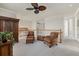 Upstairs loft area with sitting area, ceiling fan, and white railing at 20831 Valprato Ct, Venice, FL 34293