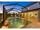 Stunning outdoor living space with a screened pool, patio, and access to the interior at 20831 Valprato Ct, Venice, FL 34293