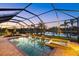 Screened pool and spa overlooking a serene lake, perfect for relaxation and outdoor enjoyment at 20831 Valprato Ct, Venice, FL 34293