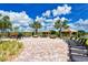 Community outdoor pool with lounge chairs, cabanas and a beautiful water view at 20831 Valprato Ct, Venice, FL 34293