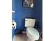 Cozy bathroom with a toilet, towel paper holder and accessories at 2181 Pine Gardens Trl, Sarasota, FL 34231