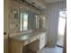 Bathroom featuring a vanity with ample counter space, storage cabinets, and a large mirror for added functionality at 2181 Pine Gardens Trl, Sarasota, FL 34231