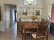 Traditional dining room featuring a wooden table, tiled flooring, and decorative wall art at 2181 Pine Gardens Trl, Sarasota, FL 34231
