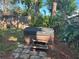 Backyard with a hot tub featuring wooden steps, offering relaxation and enjoyment in a private outdoor space at 2181 Pine Gardens Trl, Sarasota, FL 34231