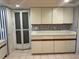 Practical kitchen layout with ample counter space, cabinets, and tile flooring at 2181 Pine Gardens Trl, Sarasota, FL 34231