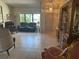 Cozy living room with tile flooring, furniture set, and a large window providing ample light at 2181 Pine Gardens Trl, Sarasota, FL 34231