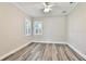 Bedroom with wood-look floors, plantation shutters, and ceiling fan at 2240 Crystal Lake Trl, Bradenton, FL 34211