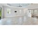 Bright living room with tile flooring, ceiling fan, and sliding barn door at 2240 Crystal Lake Trl, Bradenton, FL 34211