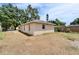 A view of the back of the house and backyard under a blue sky at 2411 5Th Avenue E Dr, Palmetto, FL 34221