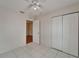 Bright bedroom featuring a ceiling fan, closet, and tiled flooring at 2411 5Th Avenue E Dr, Palmetto, FL 34221