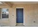 Elegant blue front door with gold hardware, complemented by a white frame and textured exterior walls at 2411 5Th Avenue E Dr, Palmetto, FL 34221